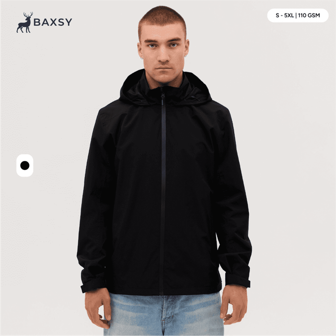 A man wearing a black Core Weather Jacket, featuring a hood and front zip, stands against a neutral background.
