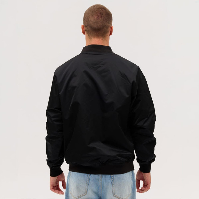 A black bomber jacket viewed from the back, featuring a simple design and ribbed cuffs.