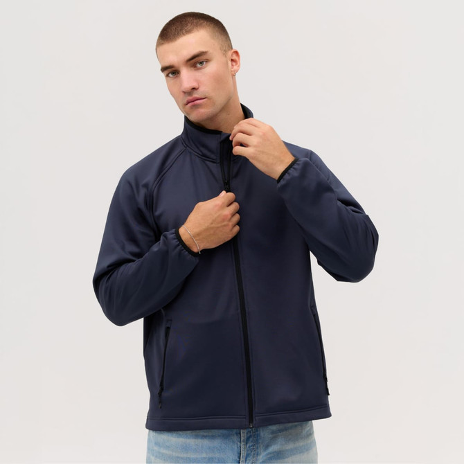 A navy Summit Bonded Jacket on a model, featuring a high collar and zip closure. The jacket has pockets and a logo.
