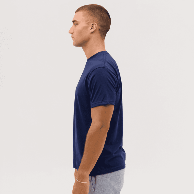 A navy blue T-shirt displayed on a model from the side, featuring a branding logo.