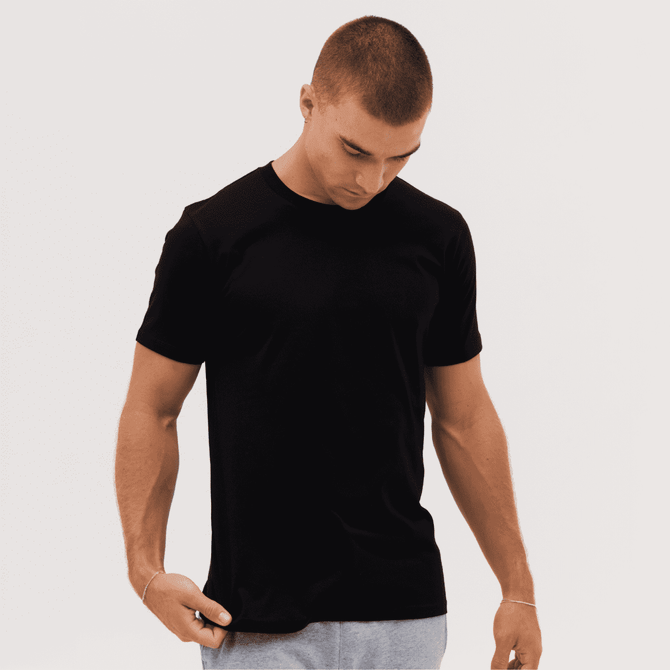 A black classic tee is displayed on a model with short sleeves and a crew neckline. The model has a neutral expression.