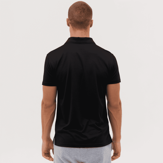 A black polo shirt is displayed, featuring a logo, viewed from the back on a model.