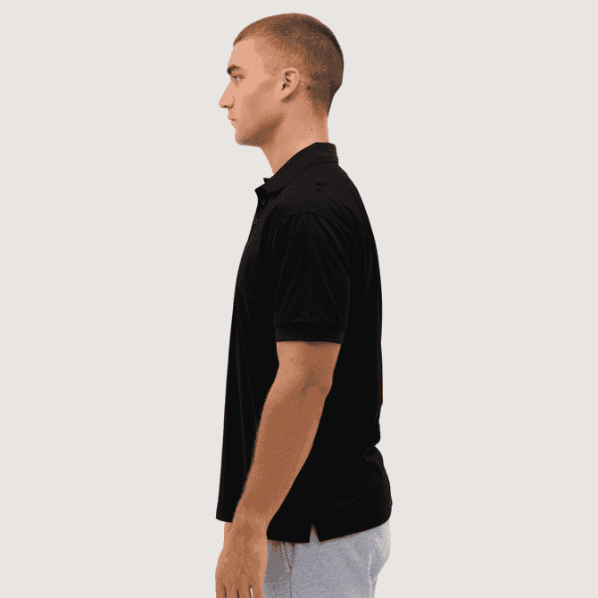 A black polo shirt displayed on a model, featuring a collar and short sleeves, with a logo on the chest.