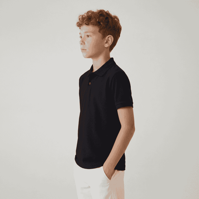 A youth polo shirt in navy blue, featuring a collar and short sleeves, worn by a child standing sideways.