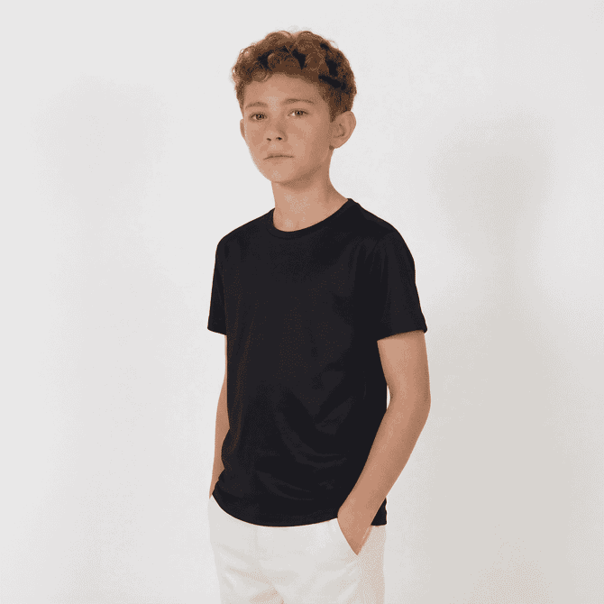 A youth black T-shirt with a simple design, worn by a young boy standing with his hands in his pockets.
