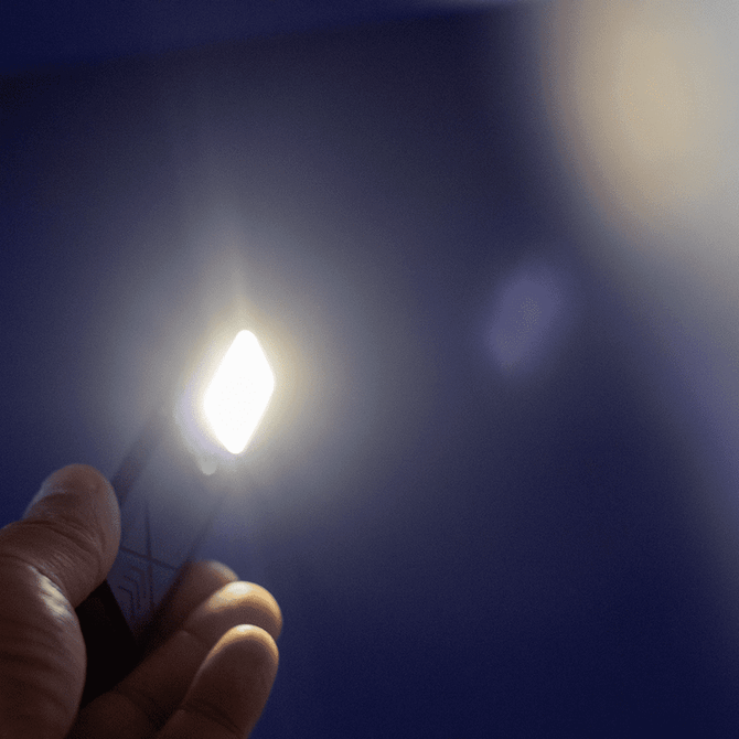 A handheld rechargeable work light emits a bright white light against a blue background. It features a logo on its surface.