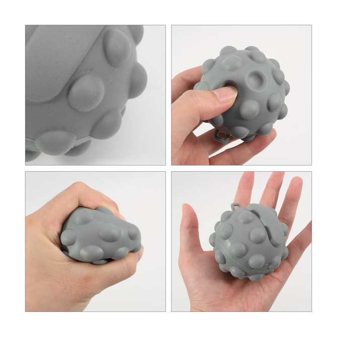 A grey stress relief ball with a textured surface, displayed in various hand positions. It features a clip for attachment.
