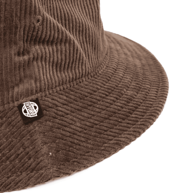 A brown corduroy bucket hat with a logo tag on the side. The texture is clearly visible in the image.