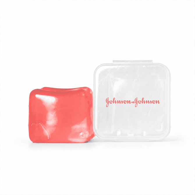 A red jelly cube sensory toy beside a transparent plastic case with a logo.
