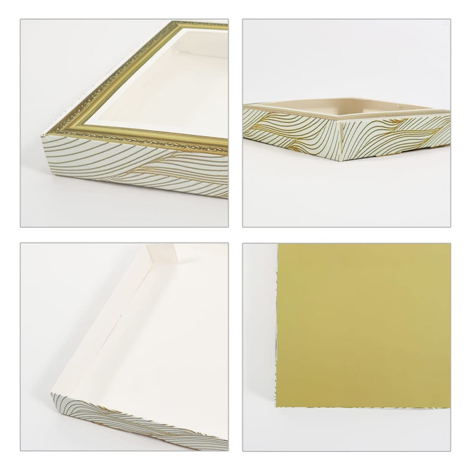 A custom picture frame-style gift box in white with a decorative gold pattern and a gold interior. It has a logo.