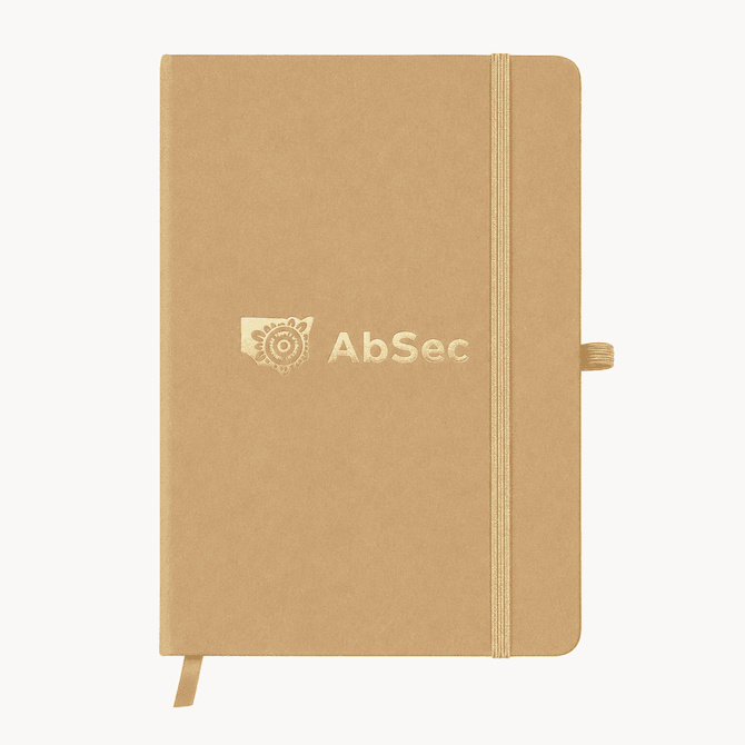 A beige A5 notebook with an elastic closure and a branding logo on the cover.