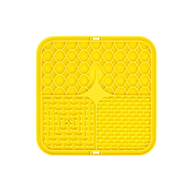 A yellow, three-section dog enrichment lick mat with honeycomb, bone, and textured patterns. It features a logo.