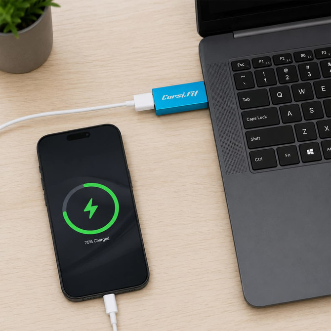 A blue A to A USB data blocker is connected to a laptop, with a phone displaying a charging status of 70%.