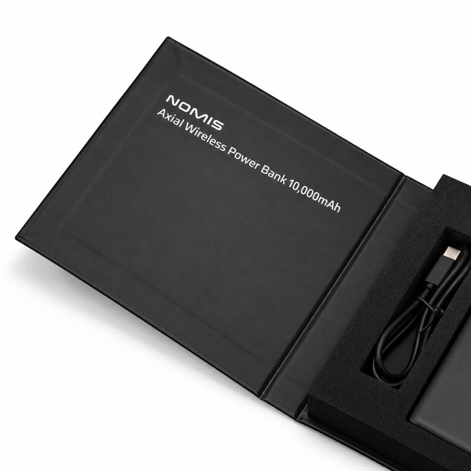 A black wireless power bank with a USB cable, displayed in a sleek box, featuring branding.