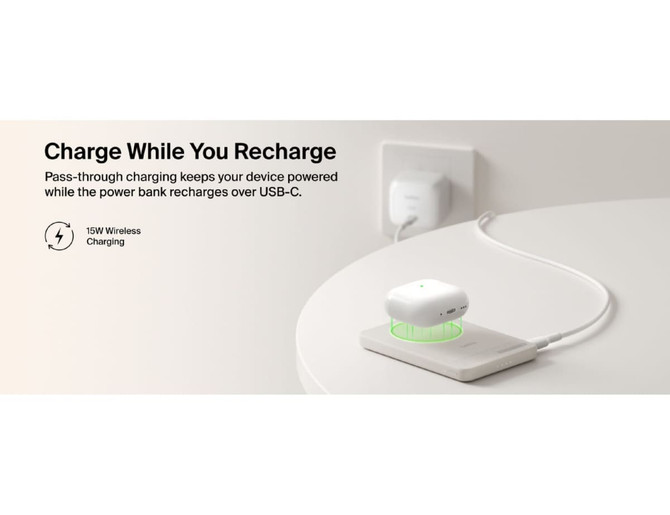 A slim, rectangular power bank in white with a charging indication light, placed on a light surface with AirPods on top.