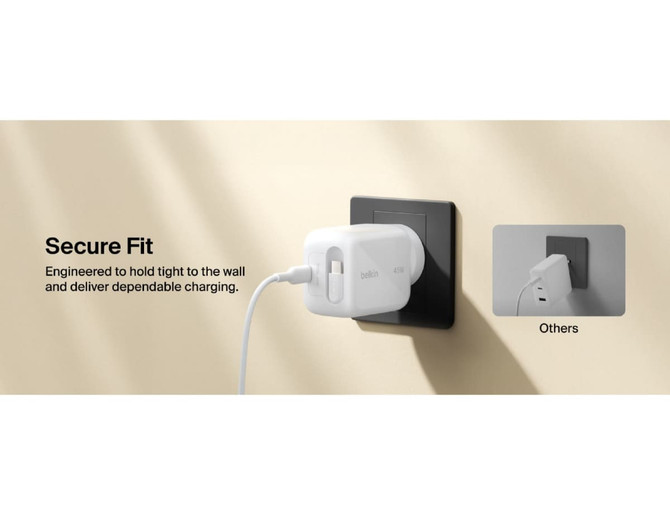 A white wall charger with a retractable design and a logo, plugged into a black wall socket.