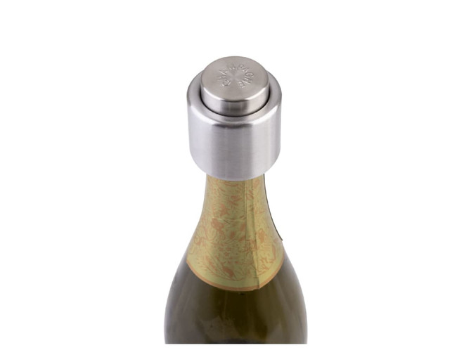 A drink bottle featuring a silver champagne stopper on top, with an ornate label partially visible on the neck.