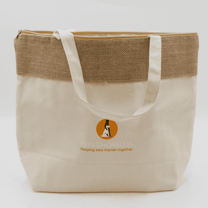 A jute and cotton cooler bag in natural and beige colours, featuring a logo on the front.