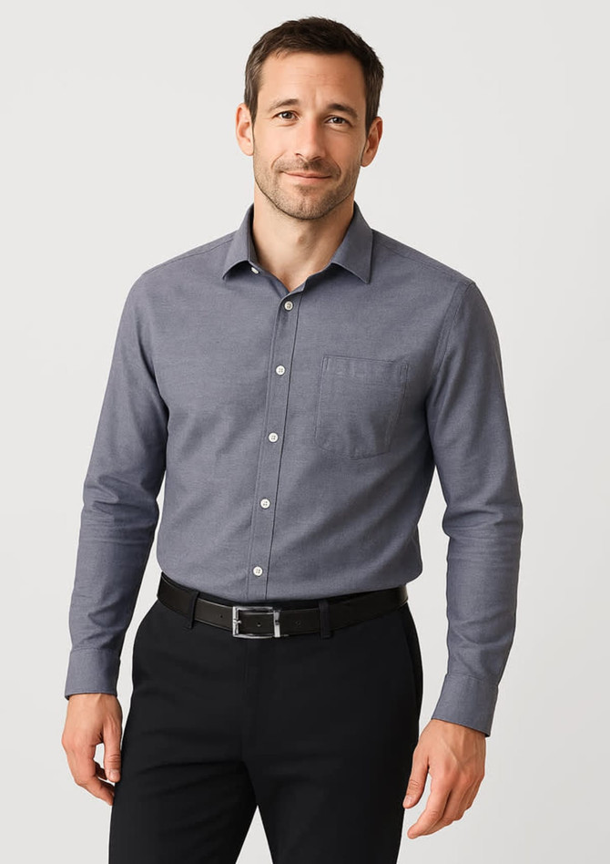A classic fit long sleeve button-up shirt in grey, featuring a front pocket and paired with black trousers.
