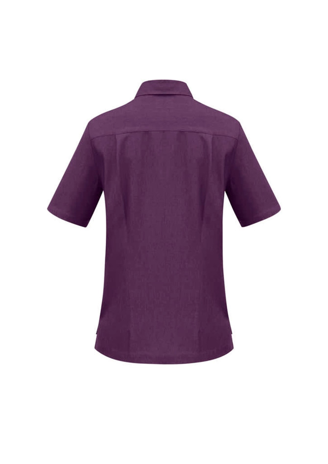 A purple overblouse with short sleeves and a collar, featuring a back yoke detail. It has a logo.