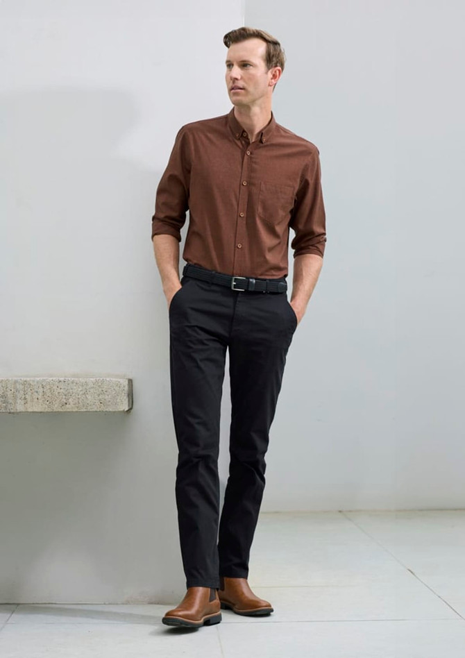 A long sleeve button-up shirt in a rich brown tone, paired with dark trousers and brown boots, featuring a subtle logo.