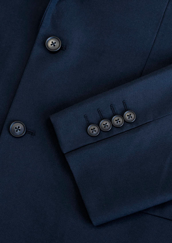 A navy blue jacket featuring a sleek design and buttoned cuffs, with a subtle logo present.