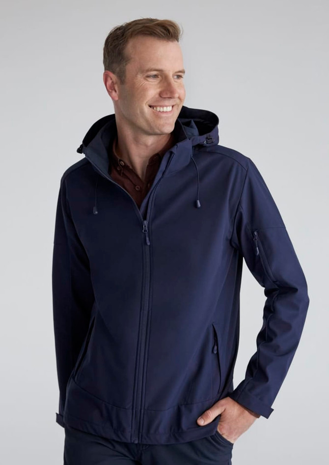 A man wearing a navy rain jacket with a hood, featuring a zipper and side pockets, and a logo on the sleeve.