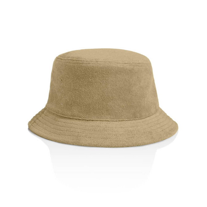 A tan Terry Bucket Hat with a soft, textured surface and a wide brim. It has a logo on the side.