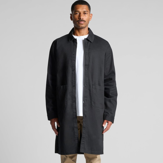 A man is wearing a black promotional "Printers Jacket" with a button-up front and side pockets.