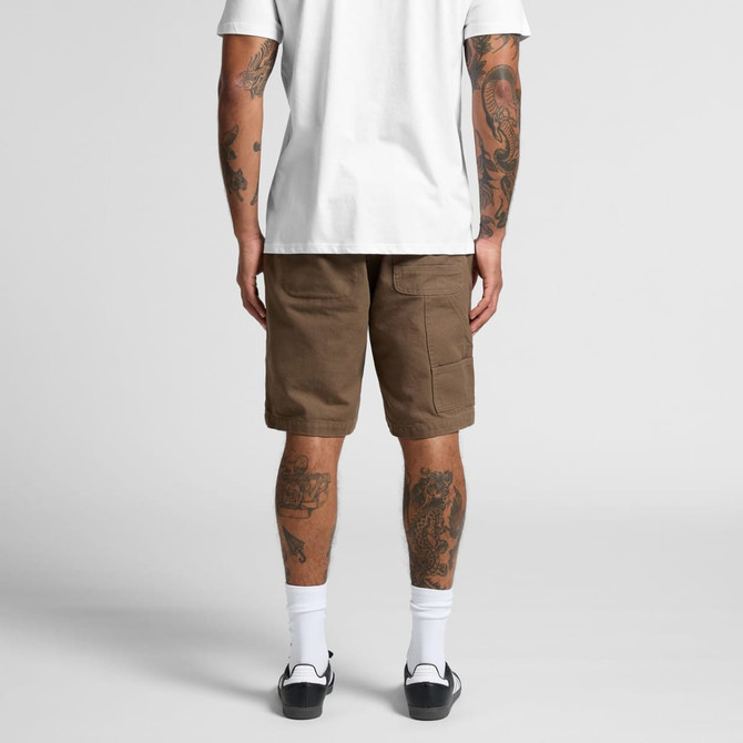 Canvas shorts in a light brown hue with cargo pockets, viewed from the back on a person wearing a white T-shirt.