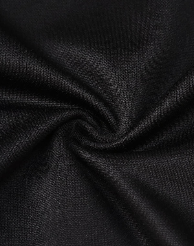 A close-up of black sustainable poly/cotton fabric, showcasing a smooth and sleek texture.
