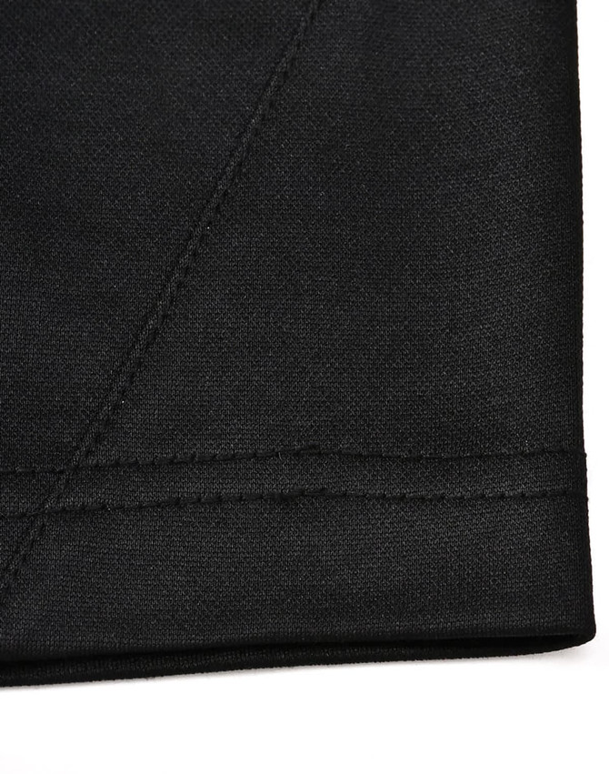A black fabric close-up featuring a contrast stitch, showcasing texture and seam detail of a polo shirt.