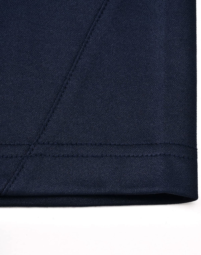 Close-up of a navy sustainable poly/cotton polo shirt, highlighting the fabric texture and stitching details.