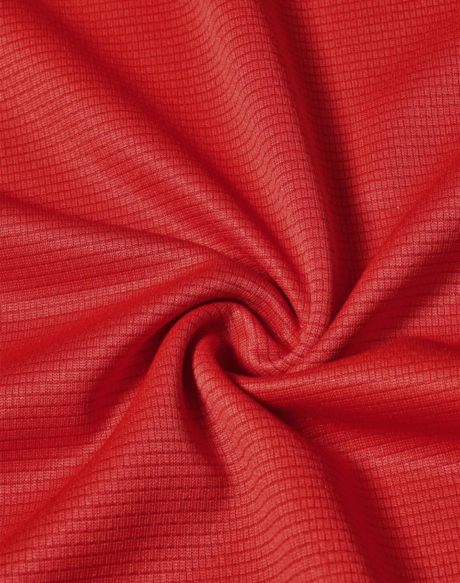 A close-up view of red fabric with a textured pattern, depicting the lightweight material of a performance t-shirt.