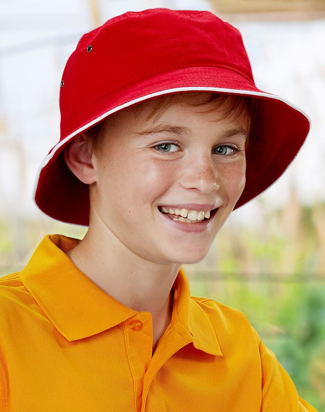 A red bucket hat featuring contrast trim, worn by a smiling young boy in an orange shirt, with a logo present.