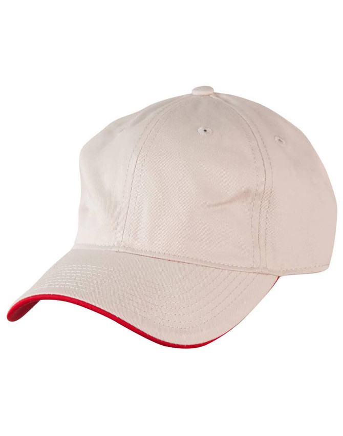 A beige cap with a contrasting red peak, featuring ventilation holes and a logo.