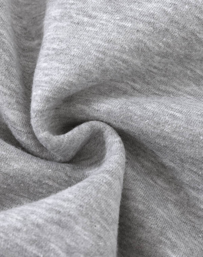 A close-up of soft, grey fabric with a slight texture, typical of a fleece jumper. It features a logo.