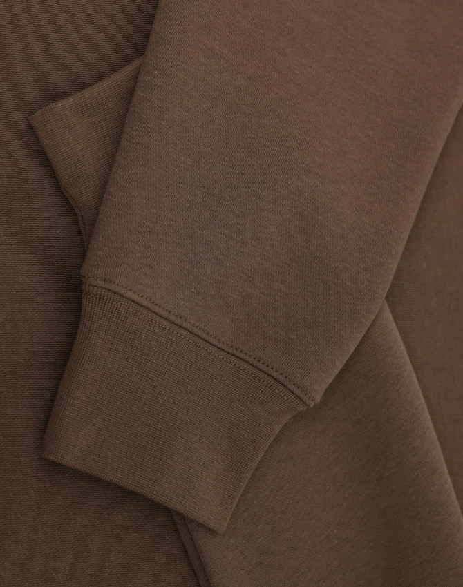 A brown crew fleece jumper with visible cuffs and fabric texture detail. Features a logo.