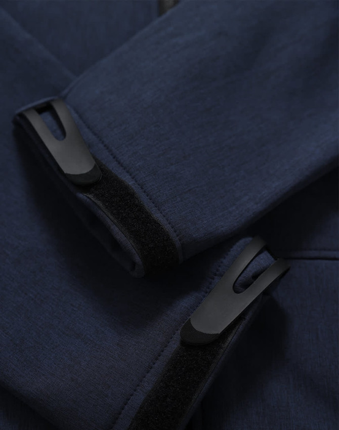 A close-up of a navy softshell hoodie featuring cuff details and a logo.