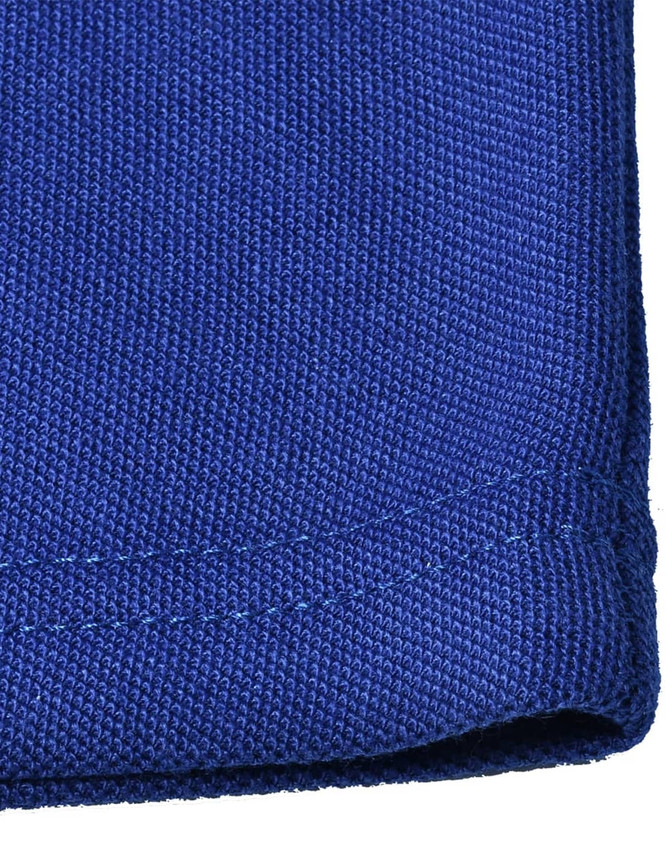 A close-up of a blue poly/cotton pique knit fabric with a neatly finished edge, featuring a logo.