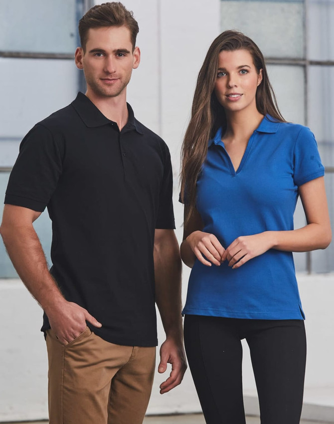 A black men's polo shirt and a blue women's polo shirt displayed on models against a light background. Each shirt has a logo.