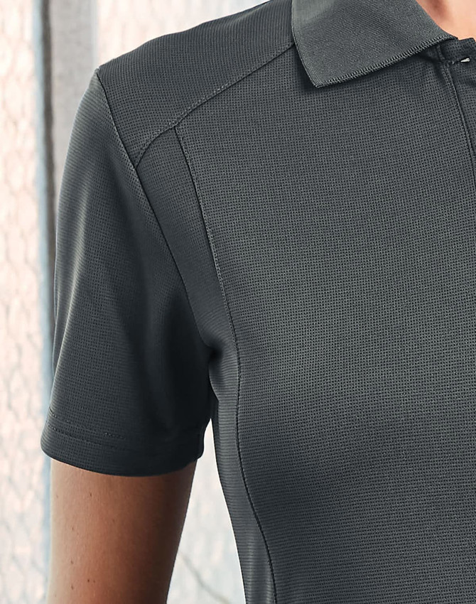 A grey polo shirt with a textured fabric and a collar, featuring a subtle logo.