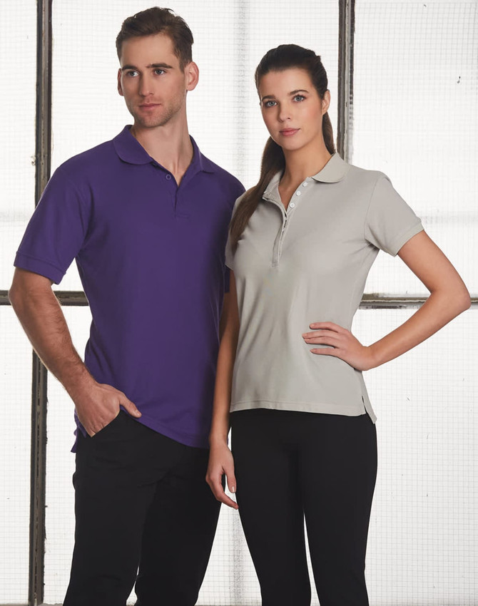 A man in a purple polo shirt and a woman in a grey polo shirt, both with collars, standing side by side.