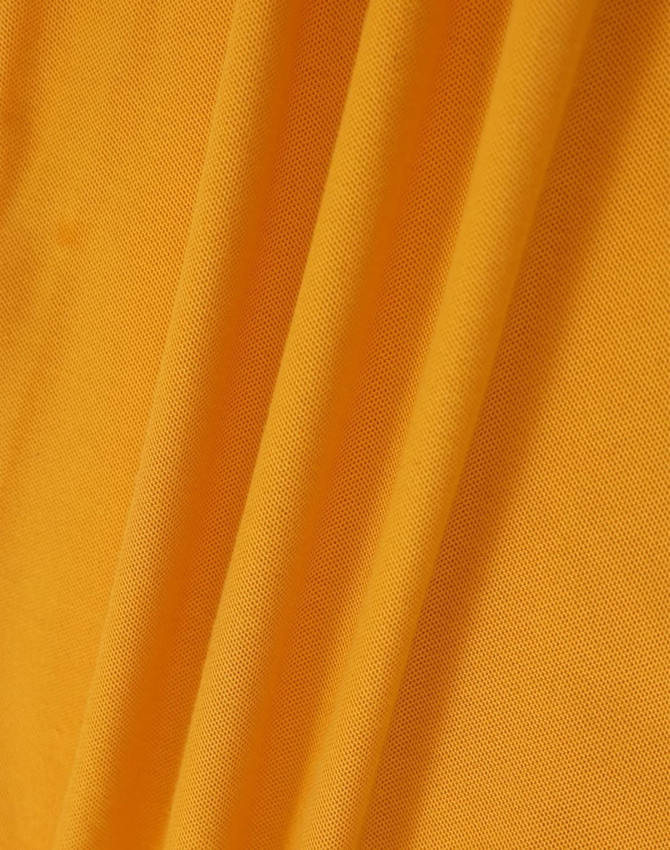 A close-up of fabric featuring a vibrant shade of yellow, showcasing the texture of the material.