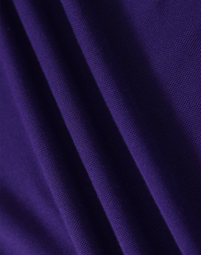 A close-up of purple fabric with a textured surface, showing folds and the material's weave.