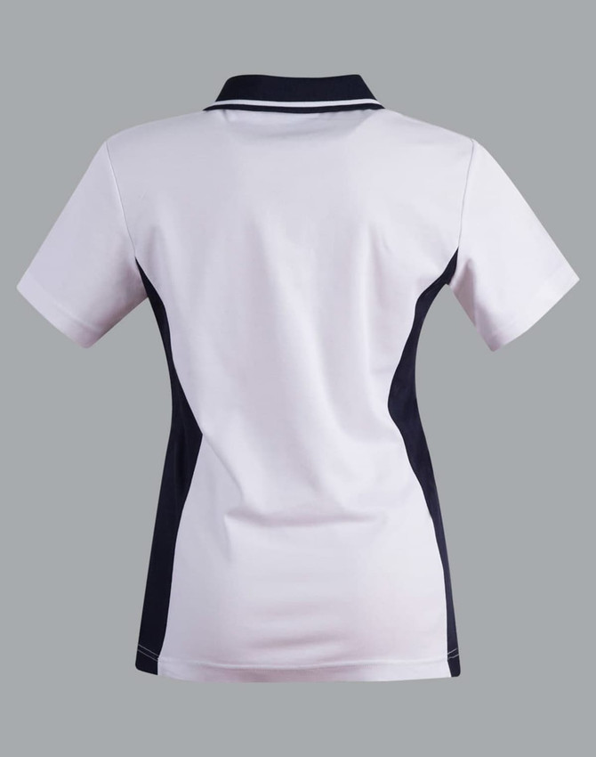 A ladies' polo shirt in white with navy contrast accents, featuring a collar and short sleeves. It has a logo detail.