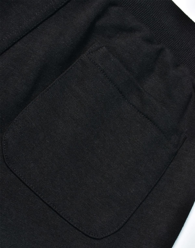 A close-up view of a black poly/cotton terry sweat pant, highlighting a back pocket detail.