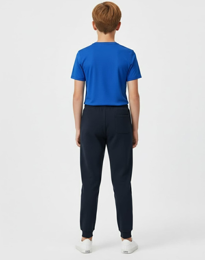 Kids' navy poly/cotton terry sweat pants displayed from the back, paired with a blue T-shirt. Features a logo.
