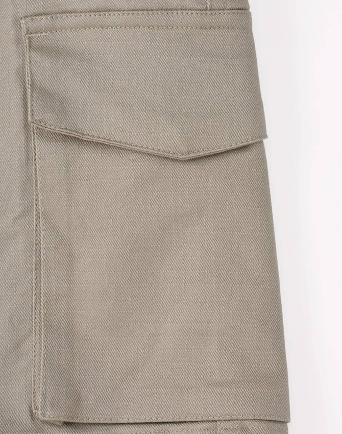 Unisex cotton stretch ripstop work shorts in a light beige colour featuring side pockets and a logo.