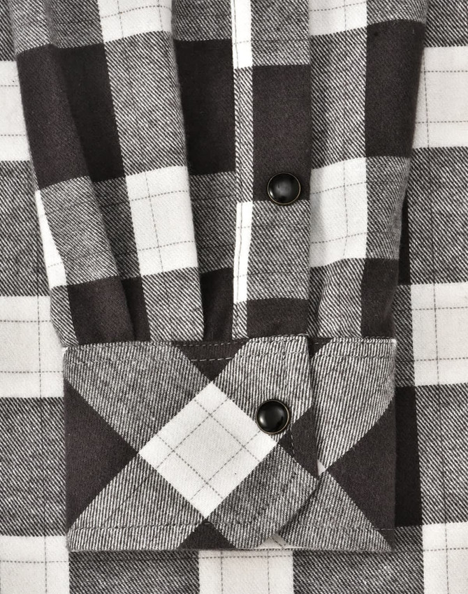 A black and white checkered flannel button-up shirt with a folded cuff, featuring a logo.